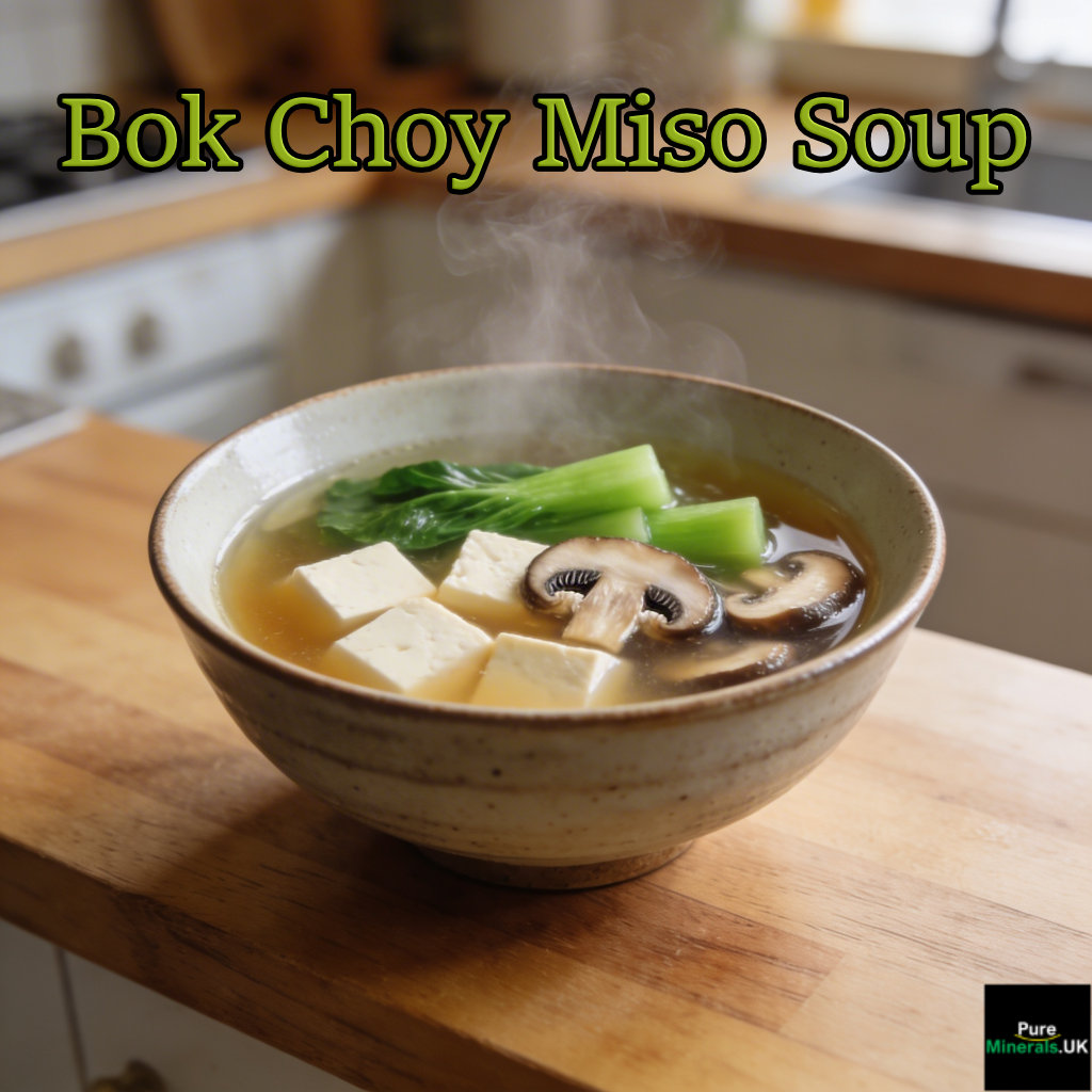 Bowl of miso soup with bok choy, tofu cubes, and sliced shiitake mushrooms on a wooden kitchen counter.