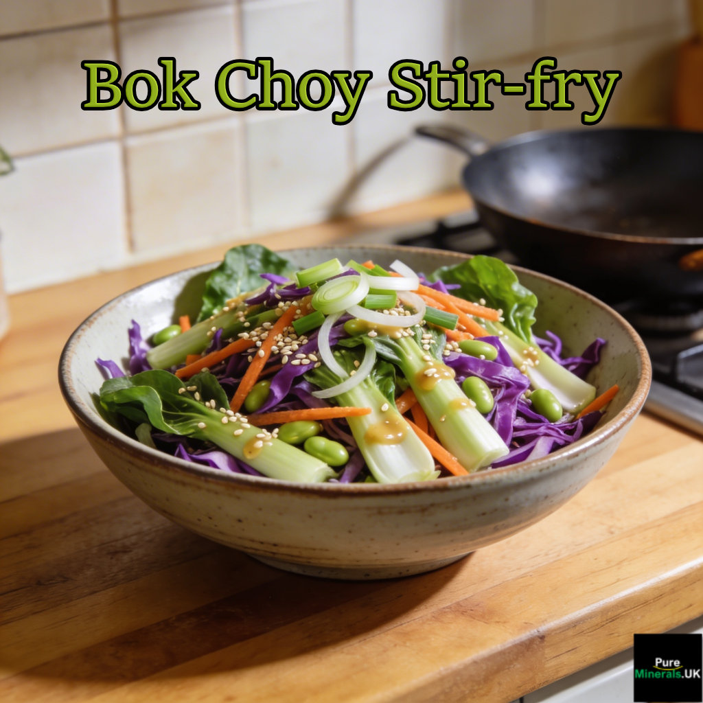 Halved baby bok choy stir-fried with garlic and sesame oil on a ceramic plate in a bright modern kitchen.