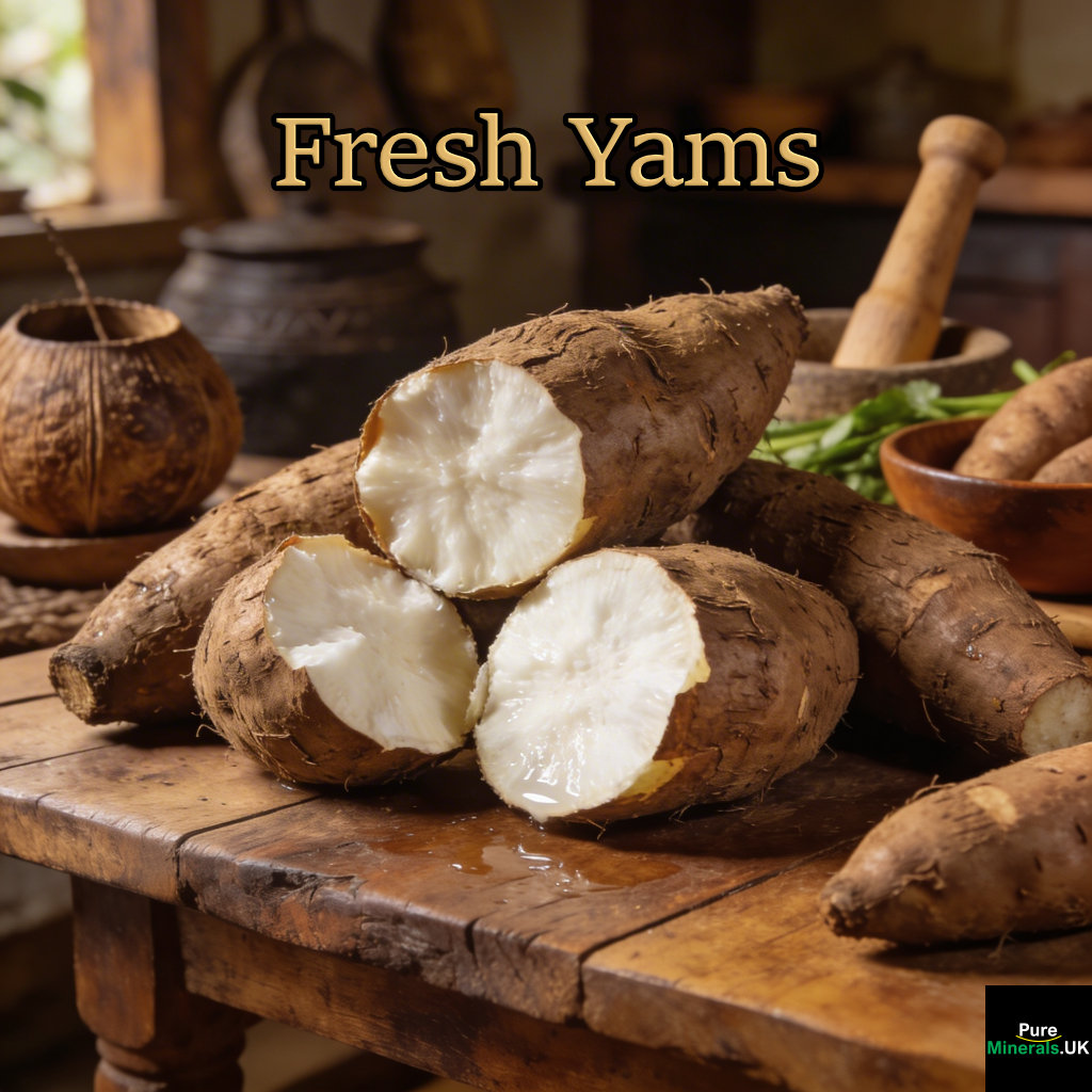 Fresh yams with rough brown skins, some cut open to reveal white flesh, arranged on a wooden table in a Ghanaian kitchen with traditional utensils in the background.